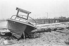 Abandoned small boat on beach.