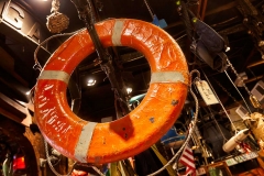 A life Preserver hangs on display in an army navy surplus store.
