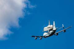 The Space Shuttle Enterprise flies piggy back on a jet in the sky.