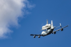 The Space Shuttle Enterprise flies piggy back on a jet in the sky.