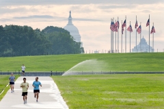 A morning view of joggers and the United States Capitol Building and Dome.