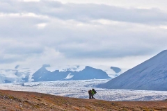 Hikers with mountains, clouds and glaciers around them, Iceland.