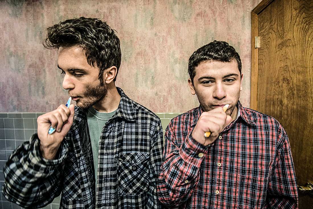 Two Young Men Brushing Teeth.