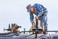 A train engineer cleaning a train.
