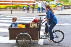 Woman riding bicycle with children.