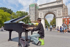 A piano player playing his piano in Washington Square Park in Manhattan, New York City.