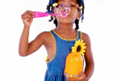 Young girl blowing bubbles.