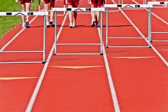 Four runners walking during Track and Field.