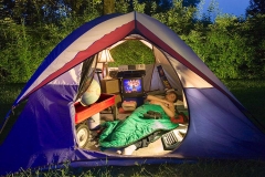 Young man sleeping in tent.