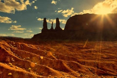 Sunset over the Three Sisters in Monument Valley, Arizona.